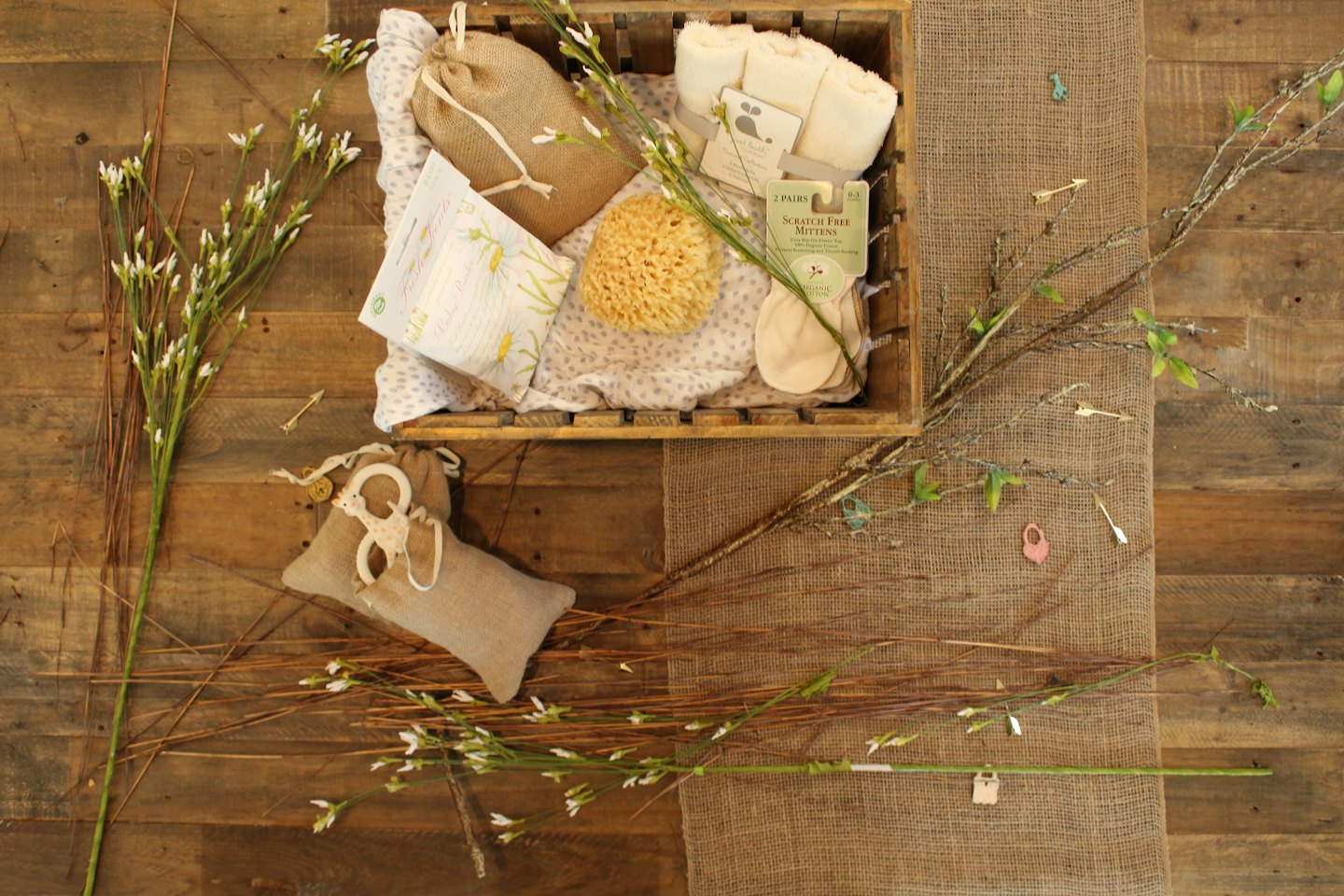 Baby products in a wooden crate and on burlap.
